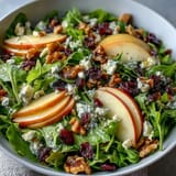 Freshly tossed Mixed Greens and Apple Bowl with crisp apple slices, crunchy walnuts, and tangy goat cheese drizzled with cider vinaigrette.