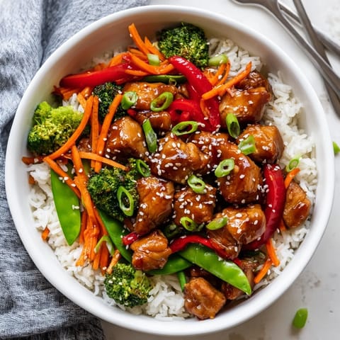 Golden sautéed chicken and crisp broccoli in teriyaki sauce make a Teriyaki Chicken Bowl ready to serve.