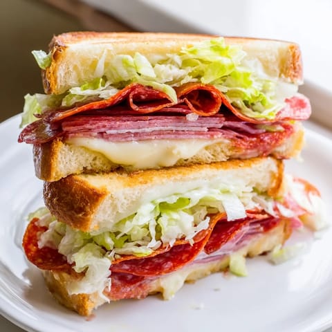 Buttery grilled sandwich, the Italian Sub Grilled Cheese, served hot with crispy crust and melted cheese.
