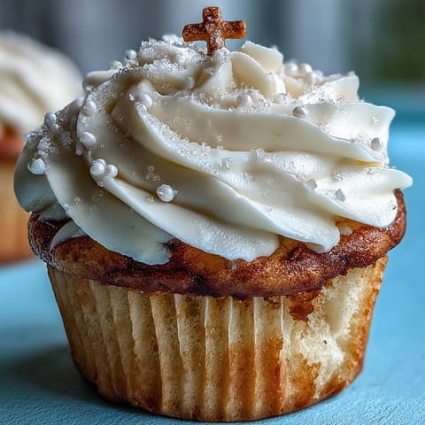Beautiful vanilla cupcakes with creamy buttercream frosting and elegant white fondant cross toppers, perfect for First Communion celebrations.
