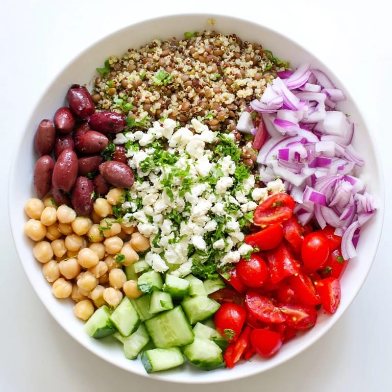 A hearty Greek Power Salad for lunch, featuring chickpeas, lentils, and crisp vegetables in a wooden bowl.
