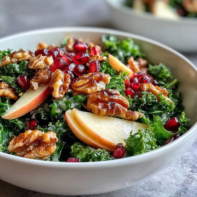 Vibrant vegetarian Kale and Pomegranate Bowl garnished with chopped nuts, served in a rustic white bowl for a healthy lunch.