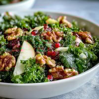 Freshly massaged kale tossed with crisp apple slices, ruby pomegranate seeds, and crunchy walnuts in a tangy apple cider vinaigrette.